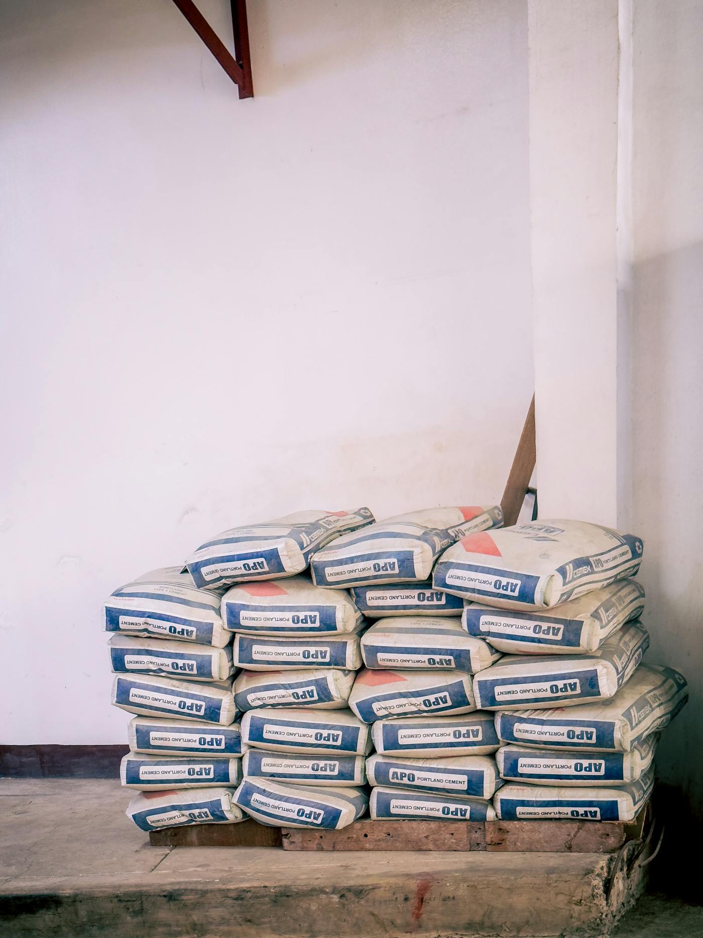 Cement bags stacked in a warehouse setting